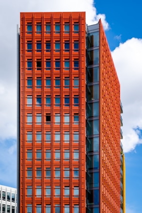 a tall red building next to a tall white building
