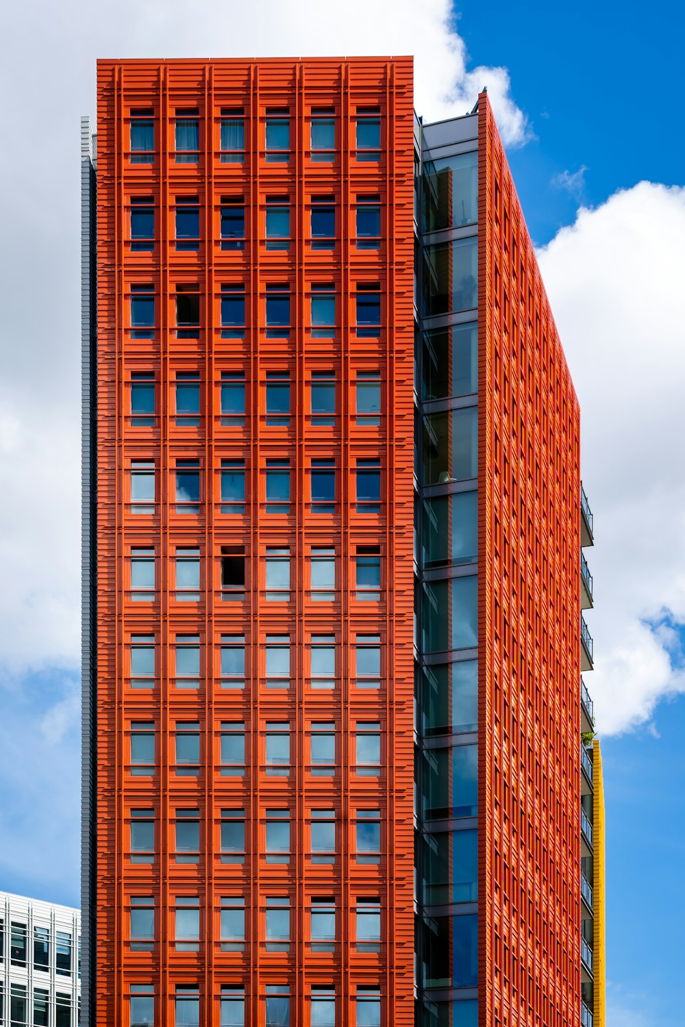 a tall red building next to a tall white building