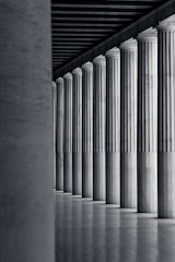 a black and white photo of a row of columns
