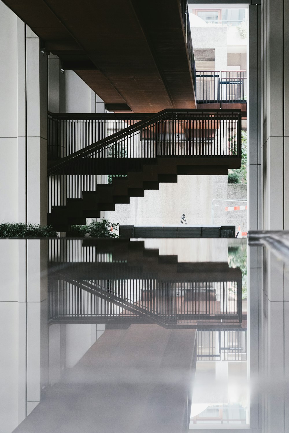 a stair case in a building with a reflection on the floor