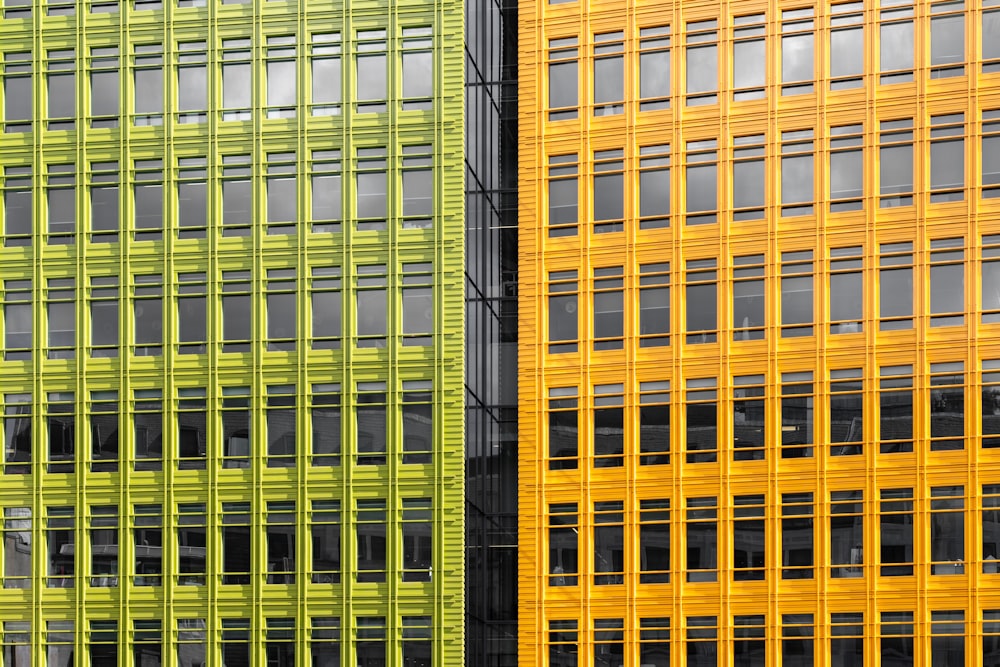 a yellow and a green building side by side