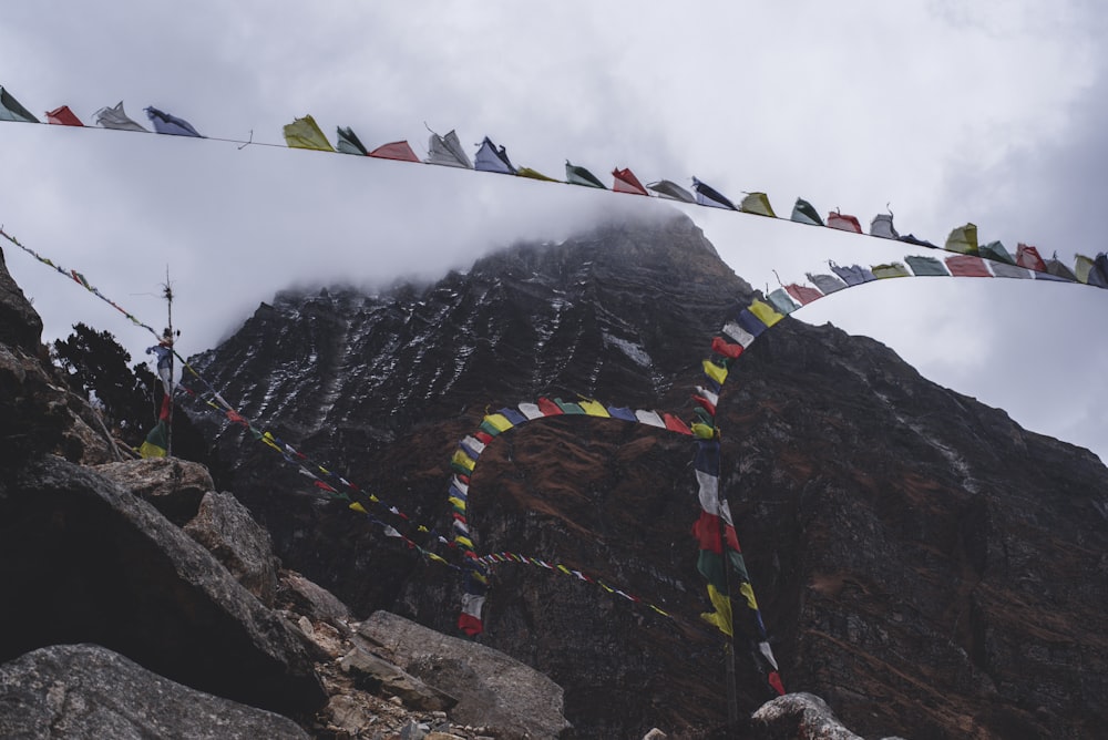 a mountain with a bunch of flags hanging off of it's sides