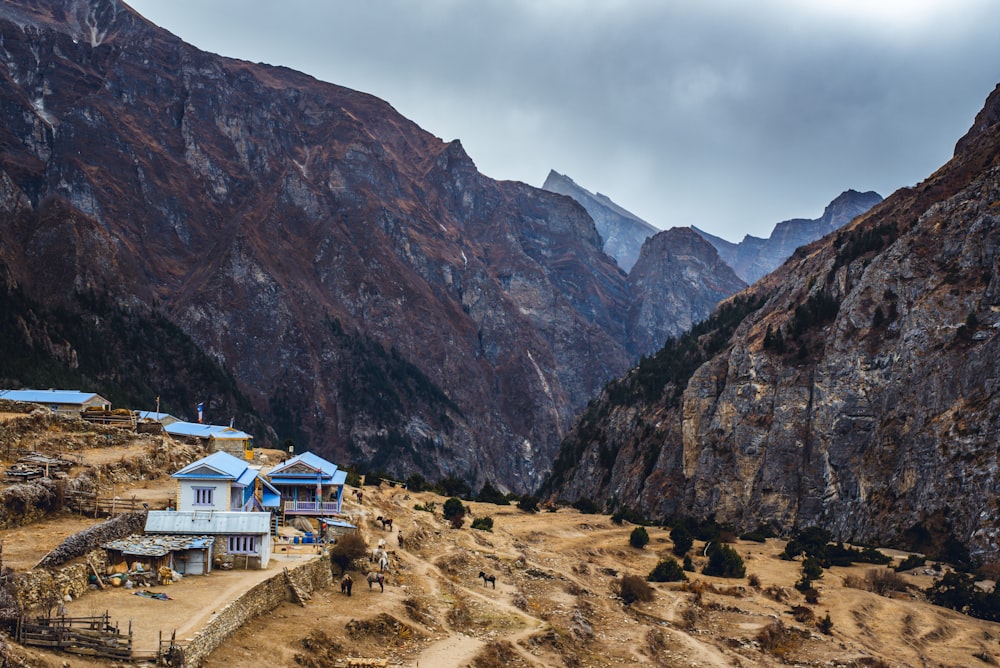 a mountain range with a house in the foreground