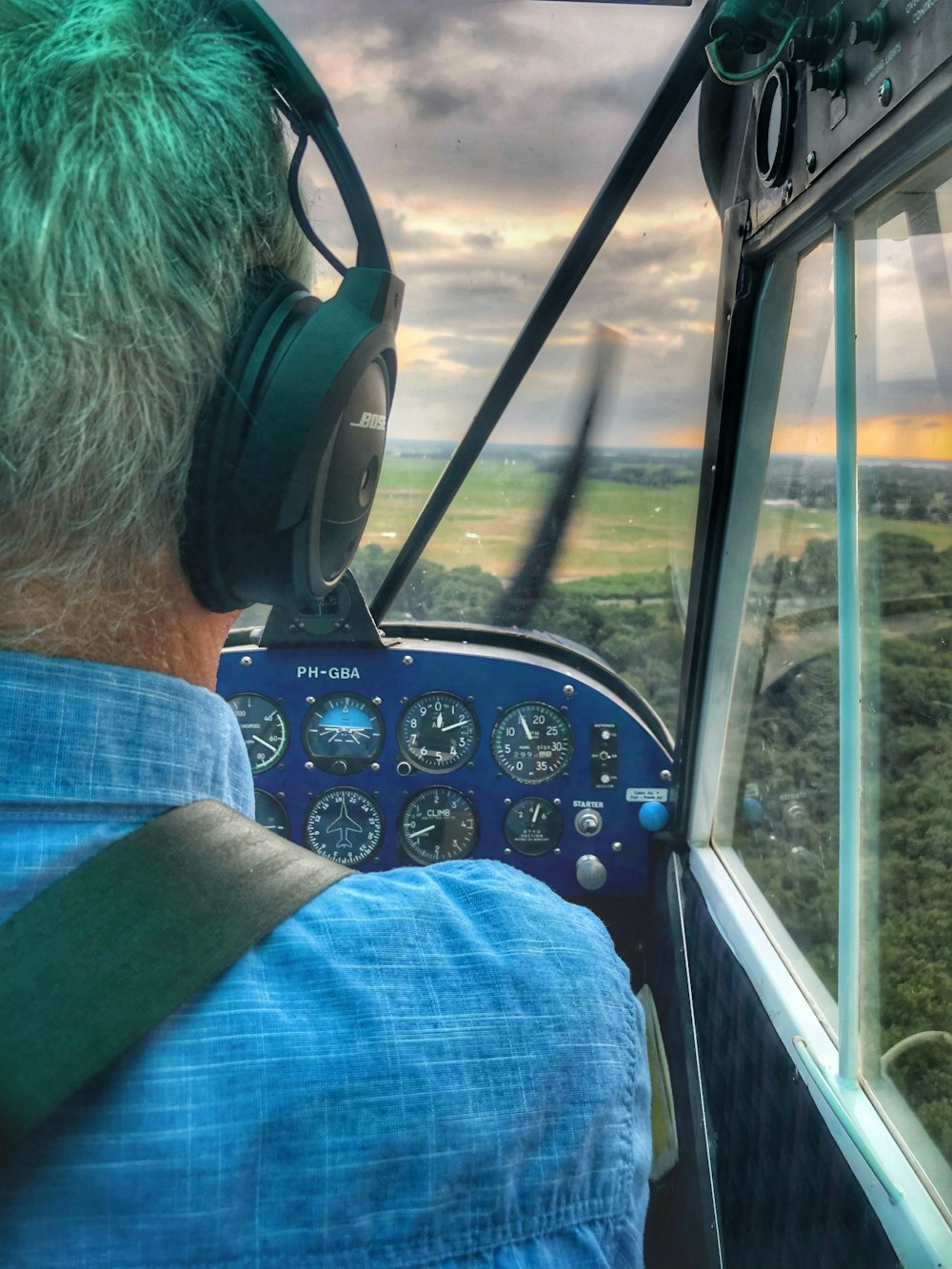 a man sitting in a helicopter looking out the window