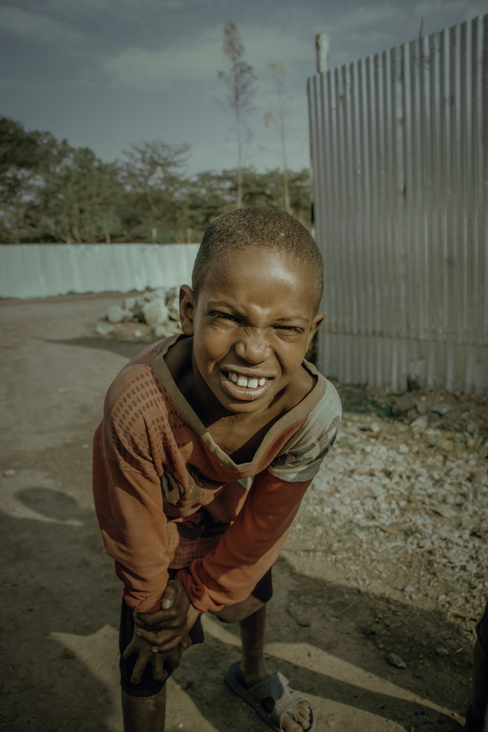 a young boy is smiling for the camera