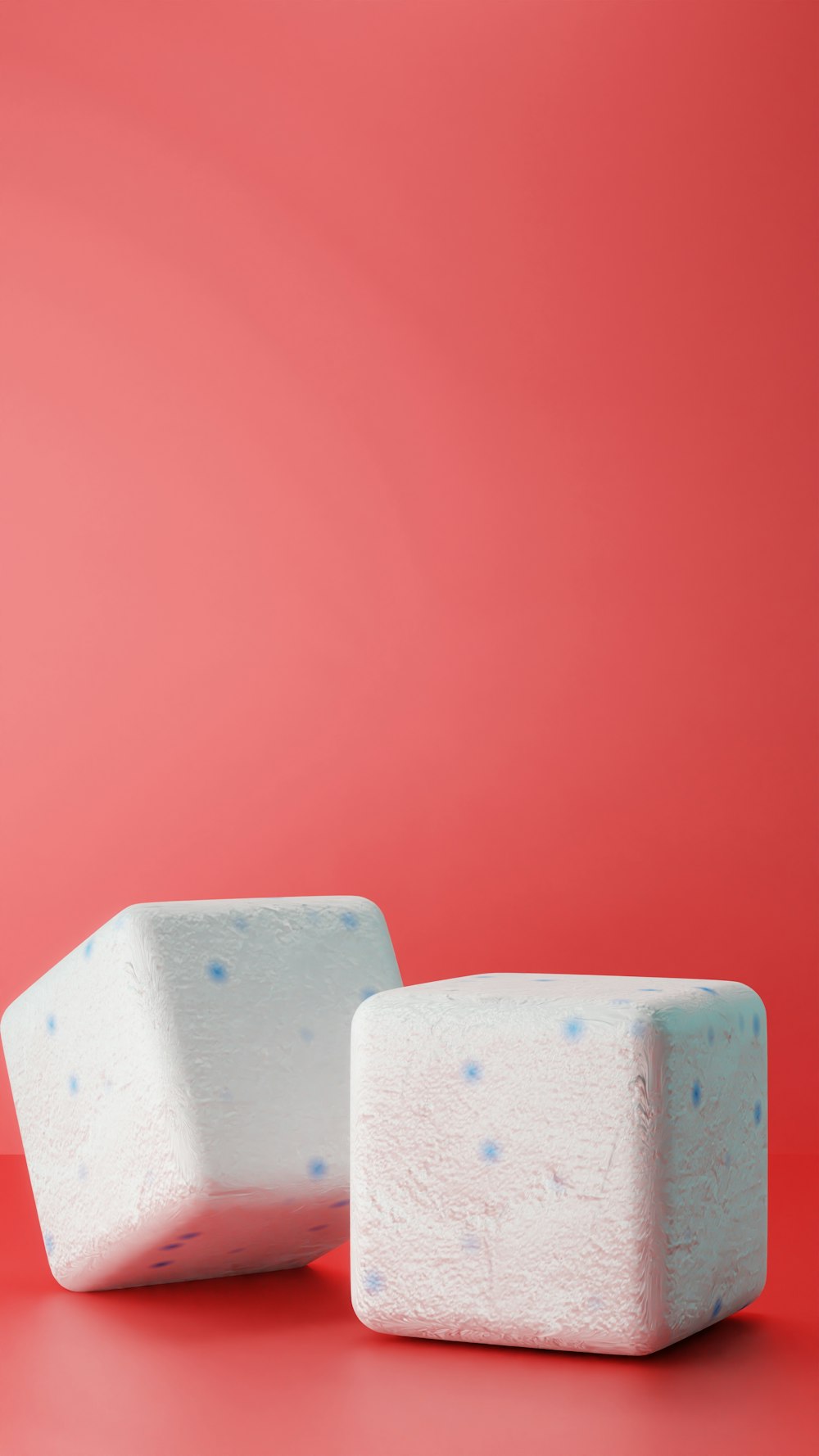 two white blocks of soap on a red background