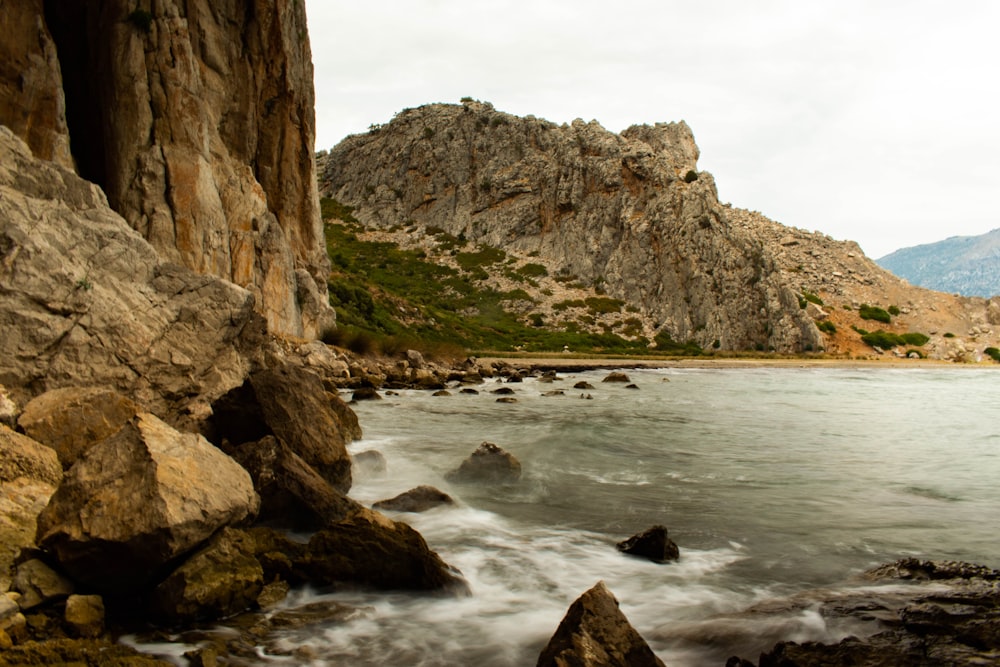 a body of water surrounded by rocks and mountains