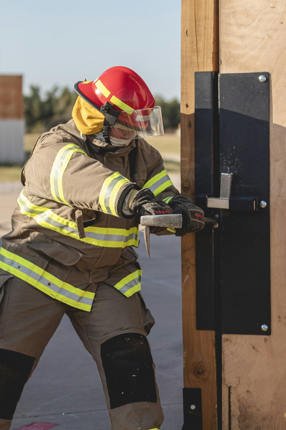a fireman in full gear is opening a door
