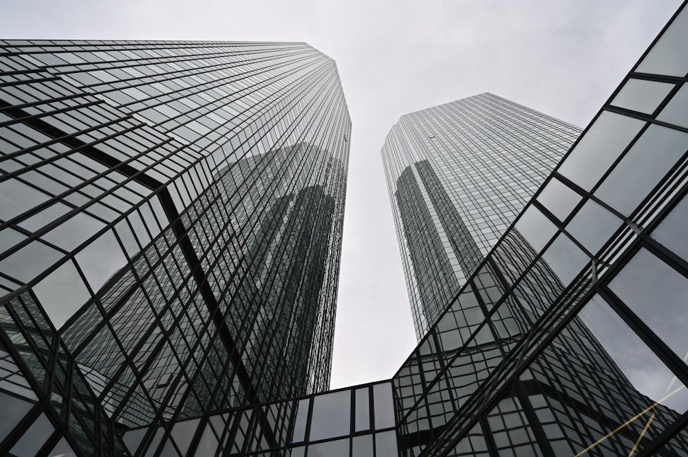 looking up at two skyscrapers from the ground