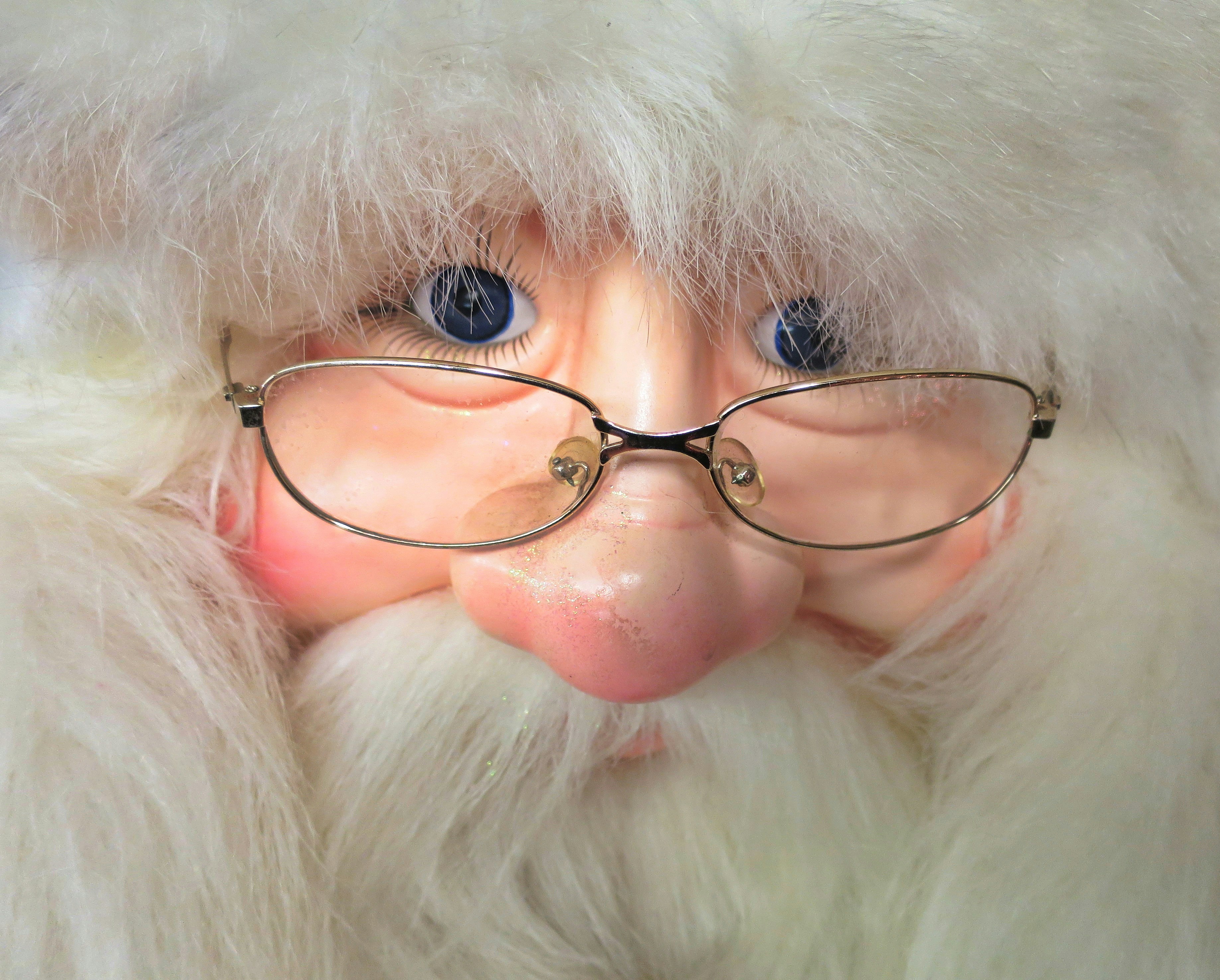 a close up of a santa clause wearing glasses