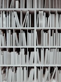a book shelf filled with lots of white books