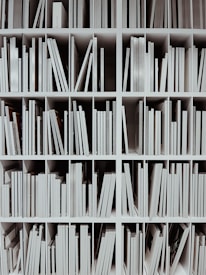 a book shelf filled with lots of white books