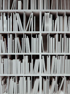a book shelf filled with lots of white books