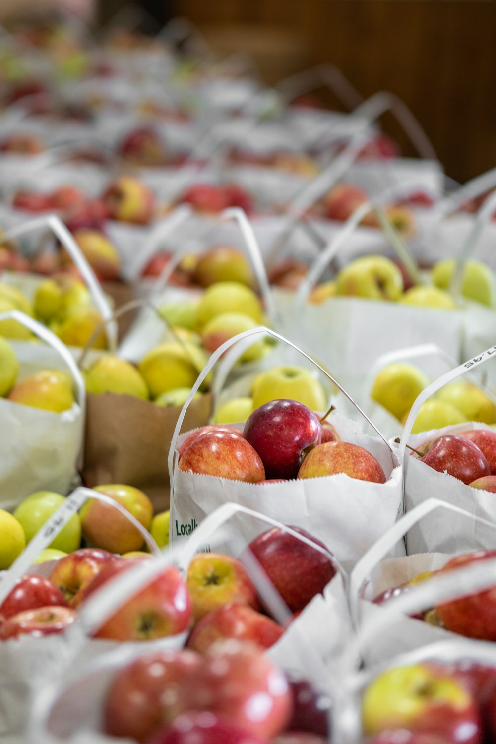 a bunch of bags filled with lots of apples