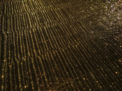 Silver and gold accents sparkling subtly on a dark, textured background.