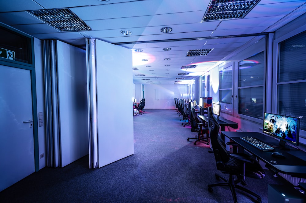 a room filled with lots of computers and desks