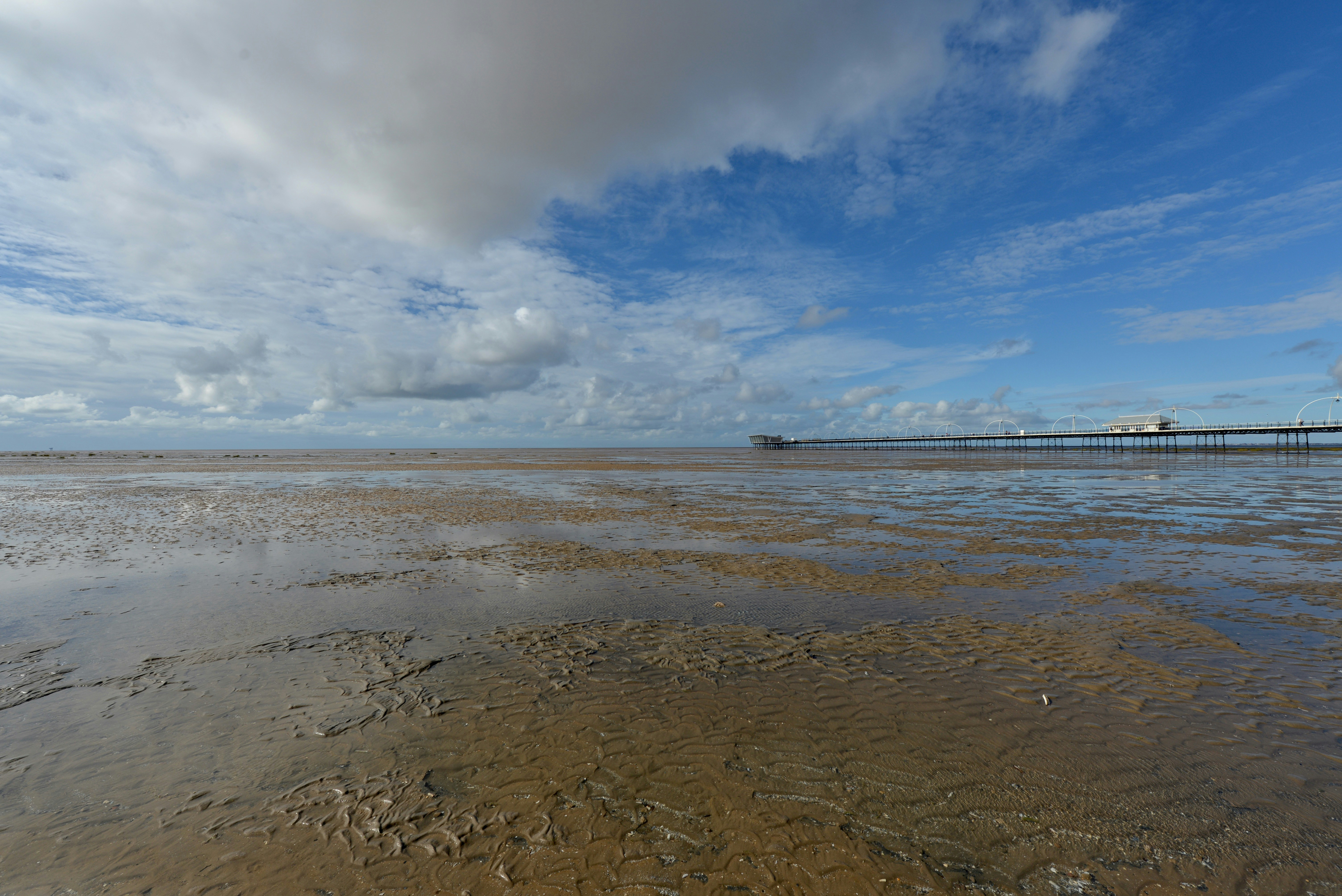 a body of water with a pier in the background
