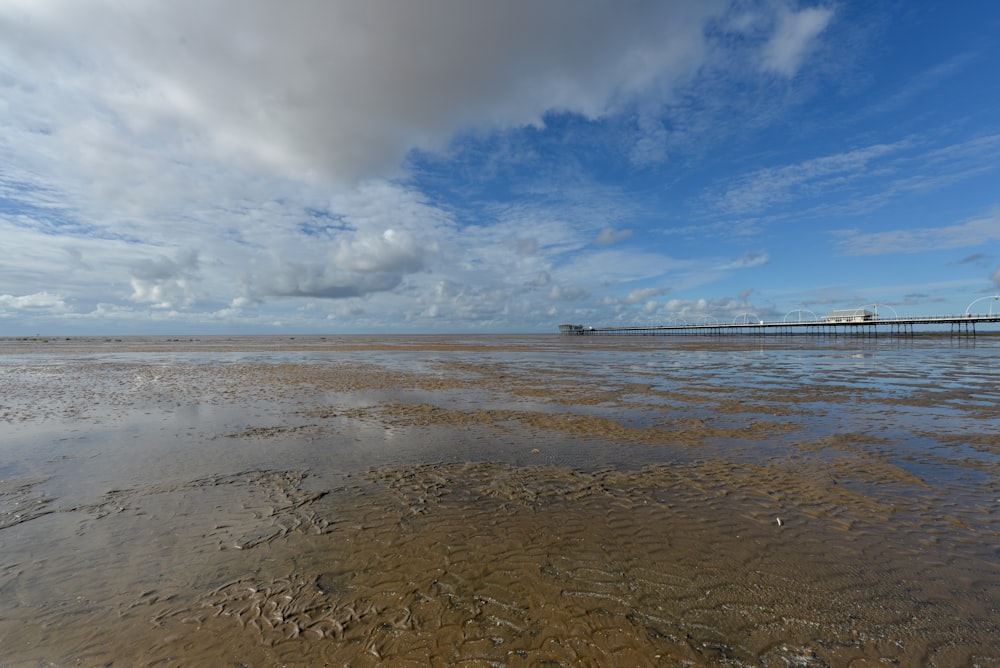 a body of water with a pier in the background