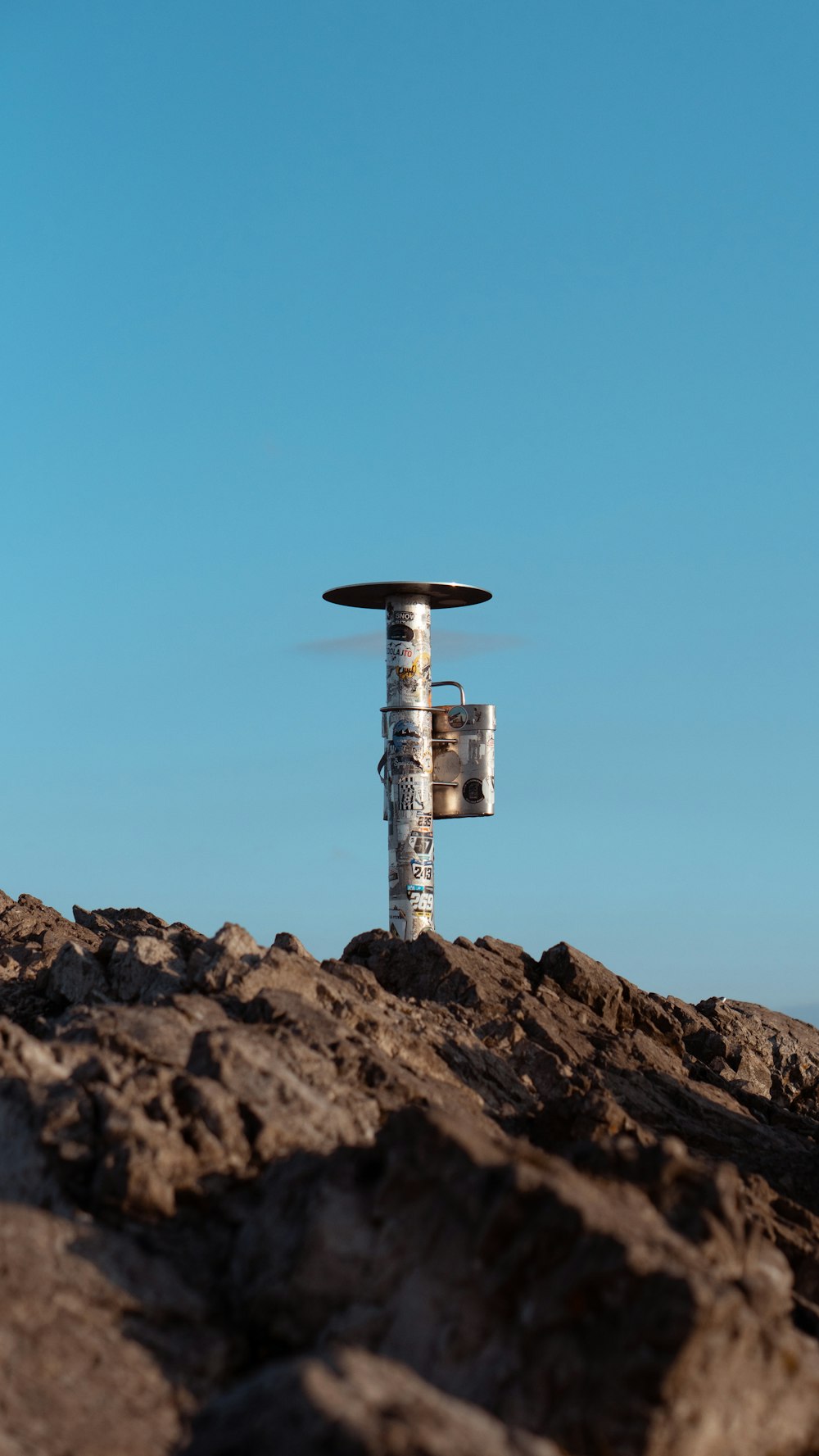 a small airplane sitting on top of a rocky hill