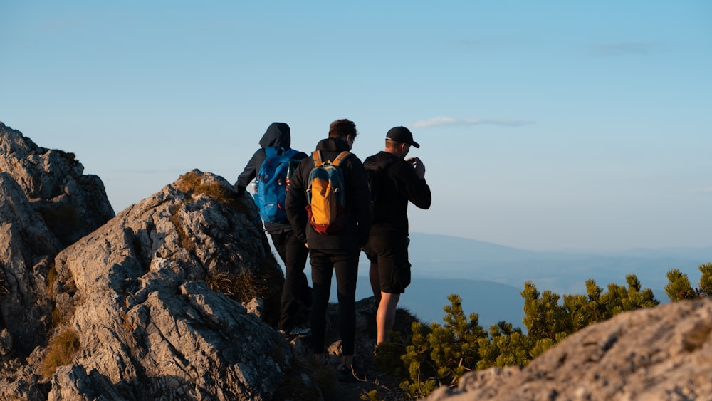 a group of people standing on top of a mountain