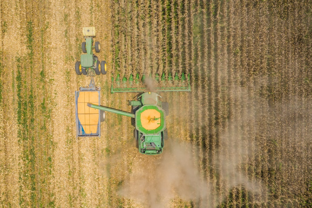 an aerial view of a tractor in a corn field