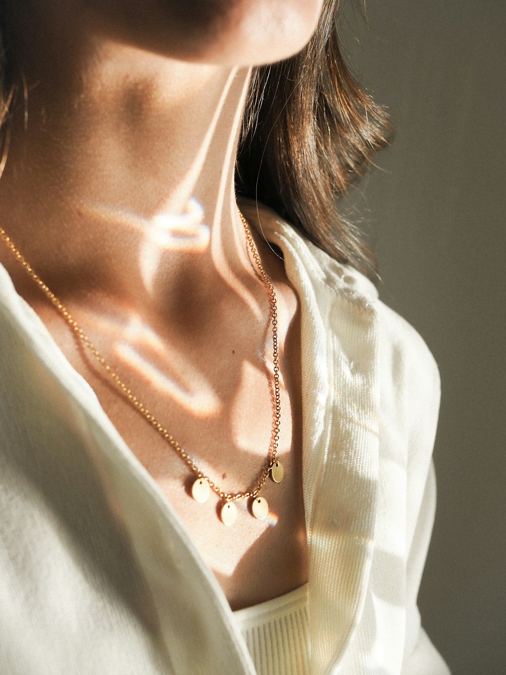 a close up of a woman wearing a necklace