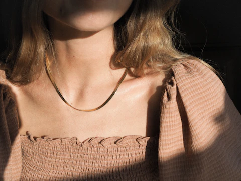 Close-up of a necklace worn with a simple outfit
