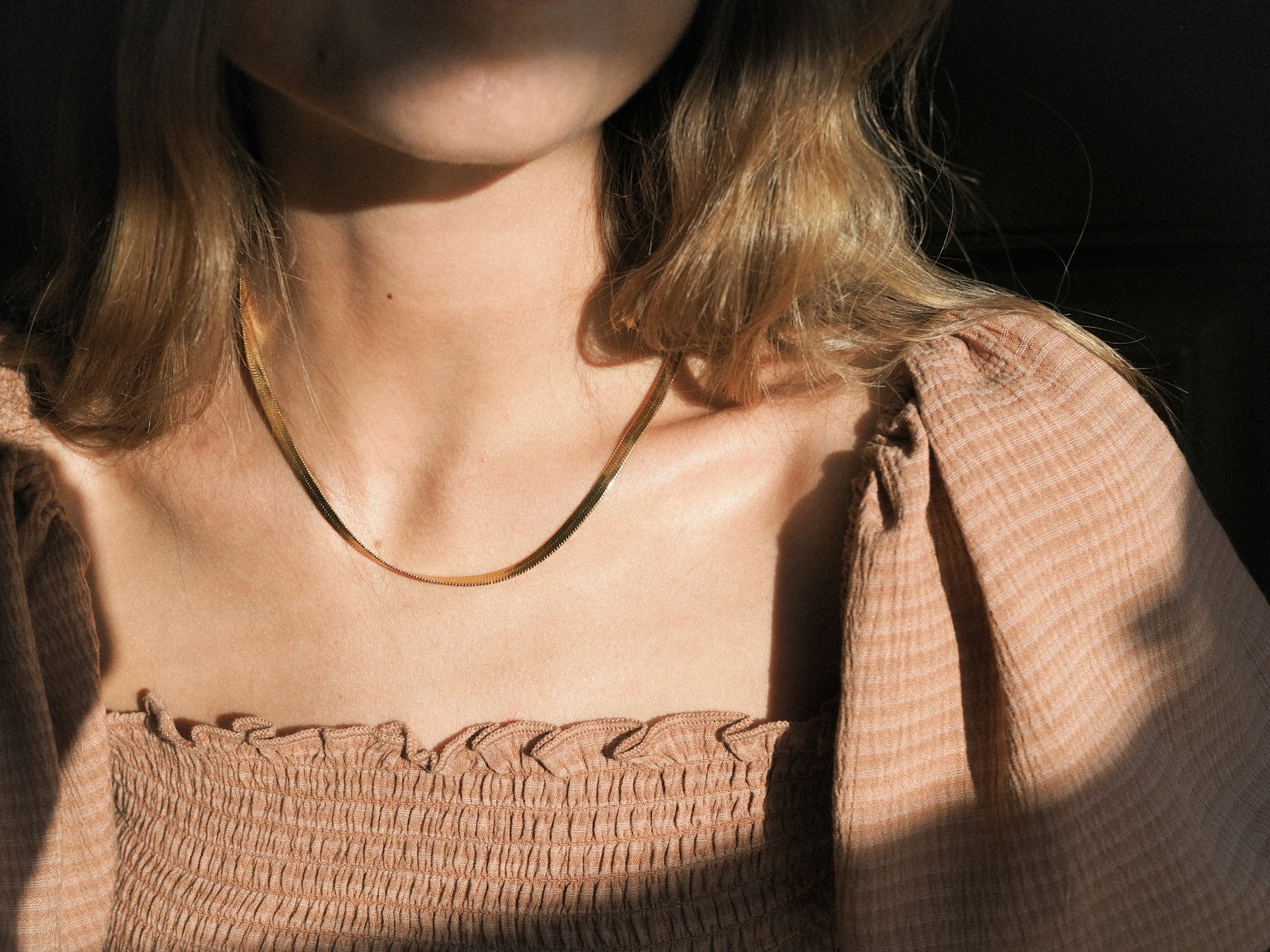 a woman with a necklace on her neck
