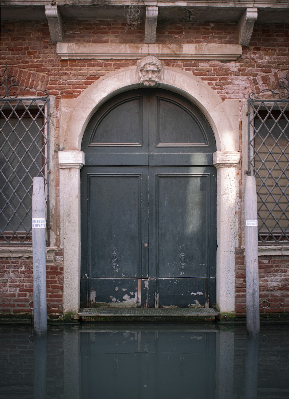 an old building with a large door and windows
