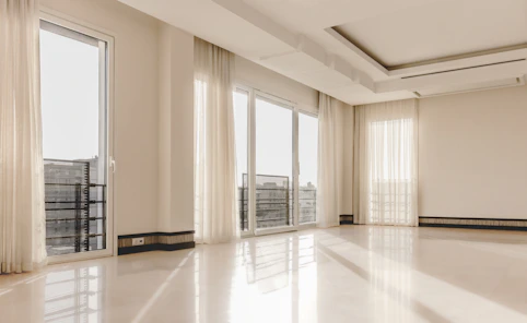 a large empty room with a lot of windows