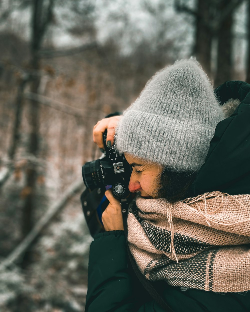 a person taking a picture with a camera in the woods