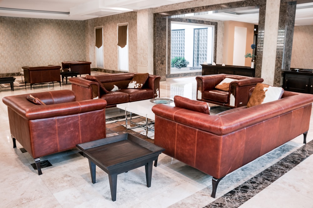 a living room filled with lots of brown furniture