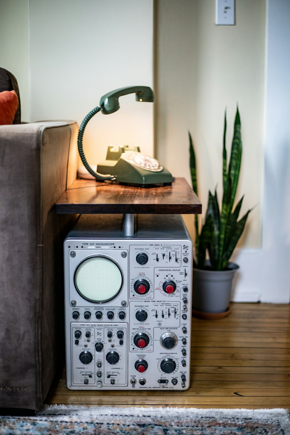 a table with a phone on top of it next to a couch