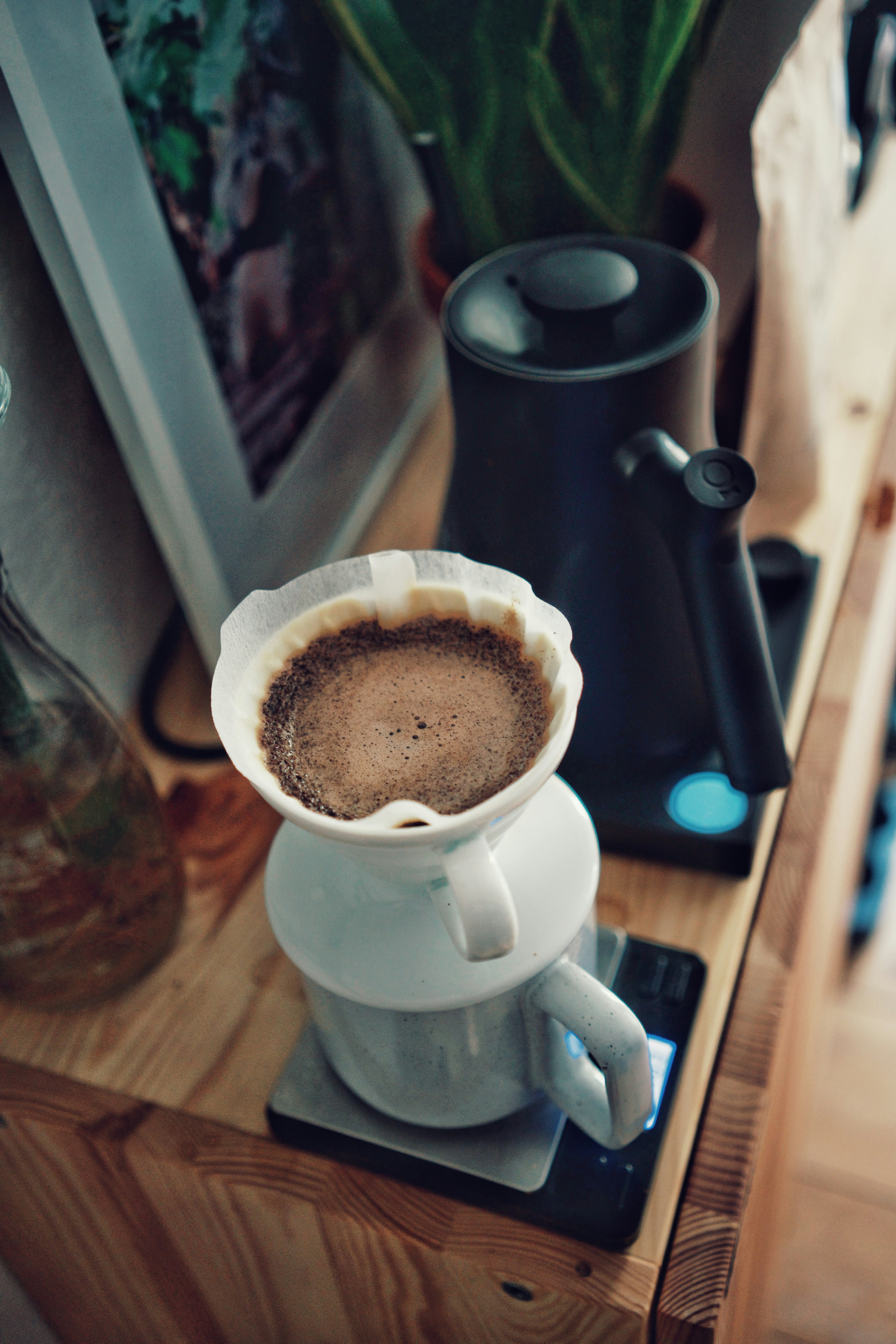 a cup of coffee sitting on top of a wooden table