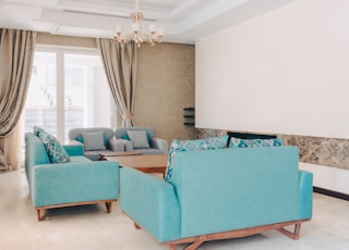 a living room filled with furniture and a chandelier