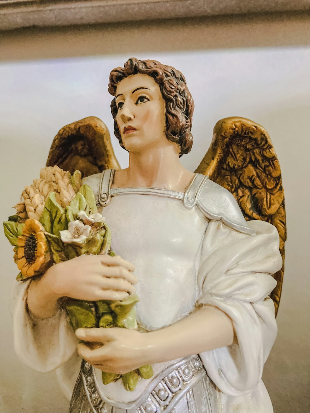 a statue of an angel holding a bouquet of flowers