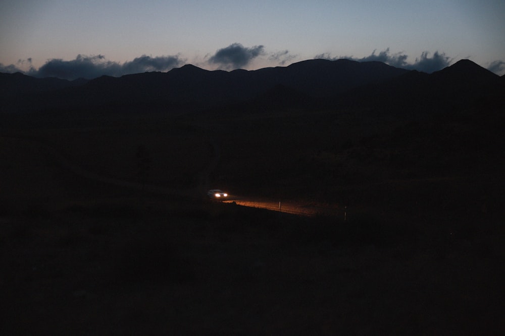 a car driving down a road at night