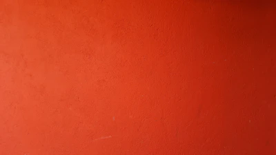 Close-up of paint roller texture showing vibrant orange paint being evenly applied.