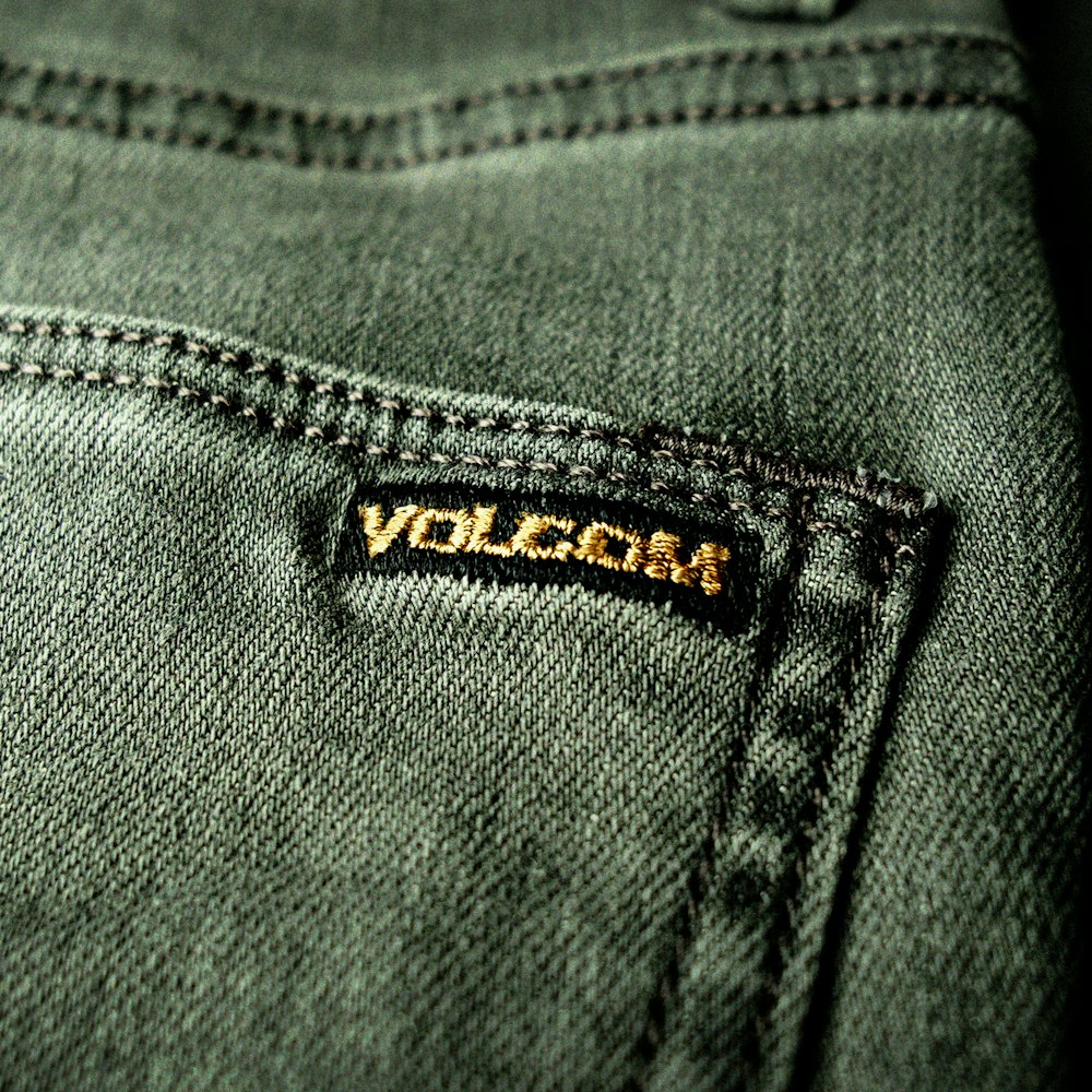a close up of a pair of jeans with the word vulcan on it