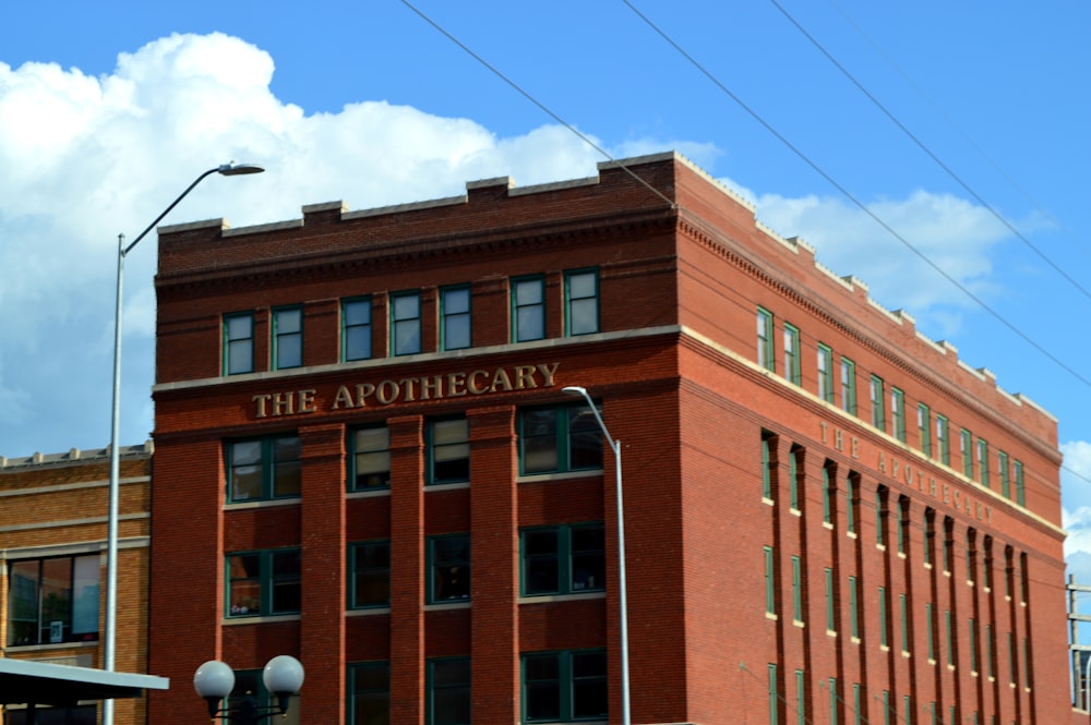 a red brick building with a sign that reads the apothecar