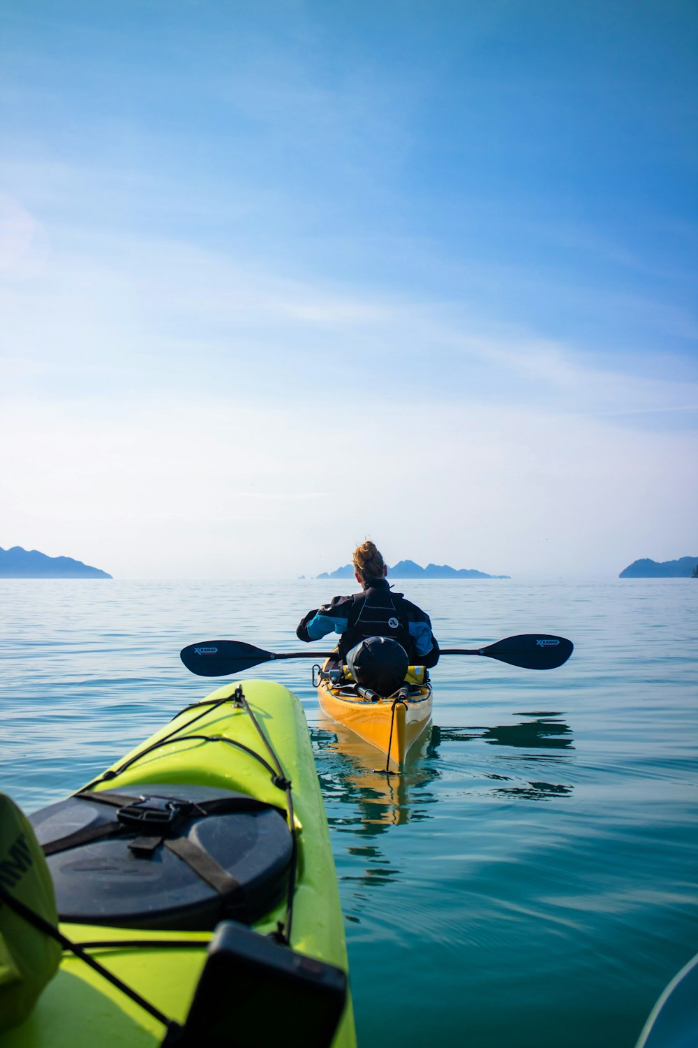 a person in a kayak paddling on the water