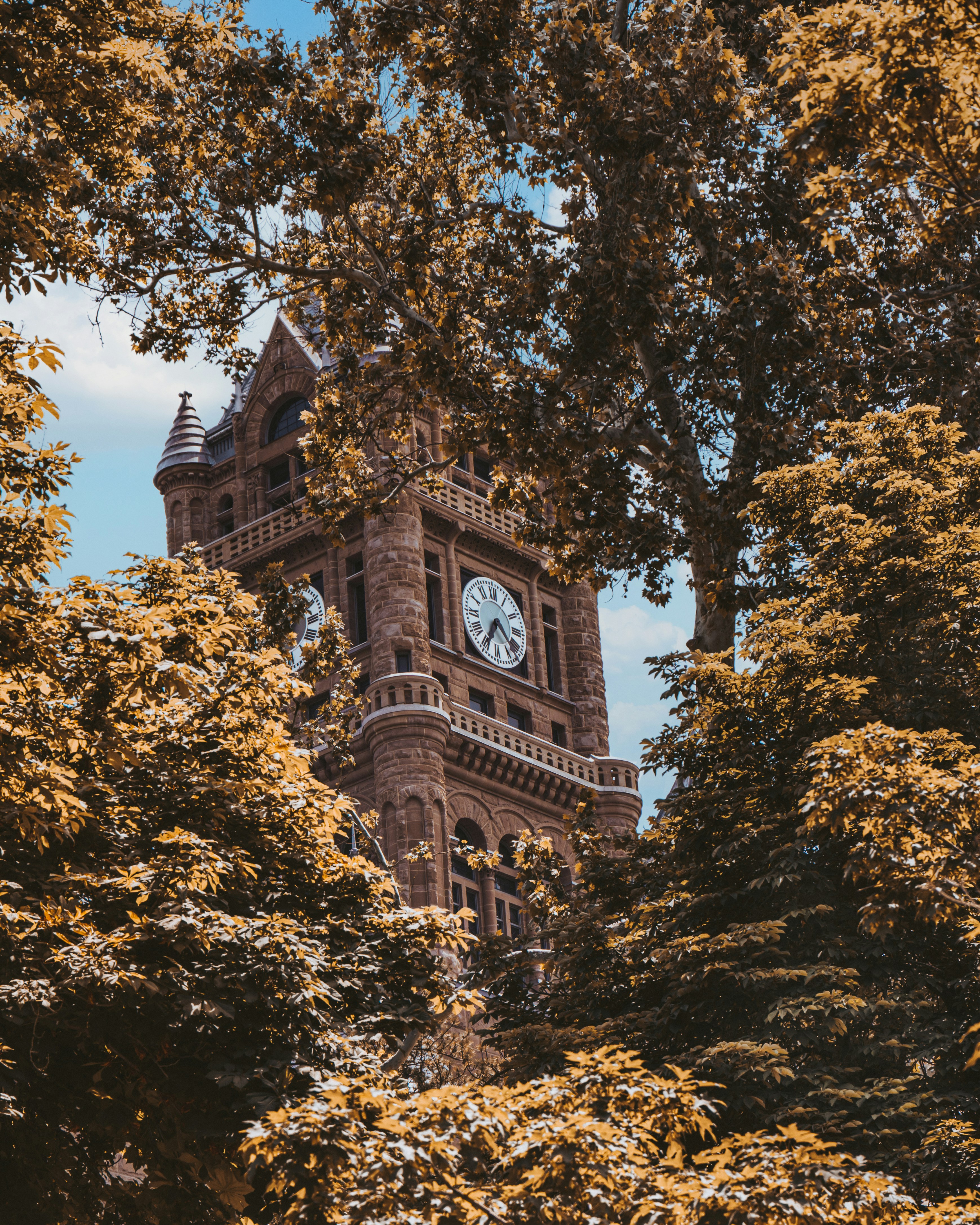 a tall clock tower with a clock on each of it's sides