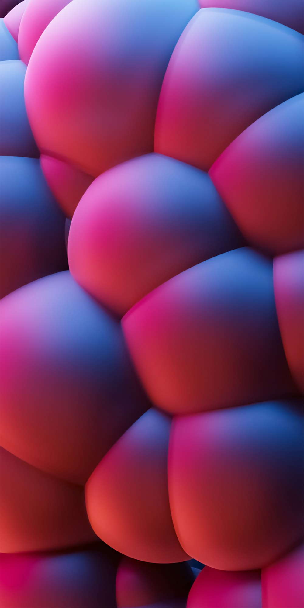 a bunch of pink and blue balls are stacked together