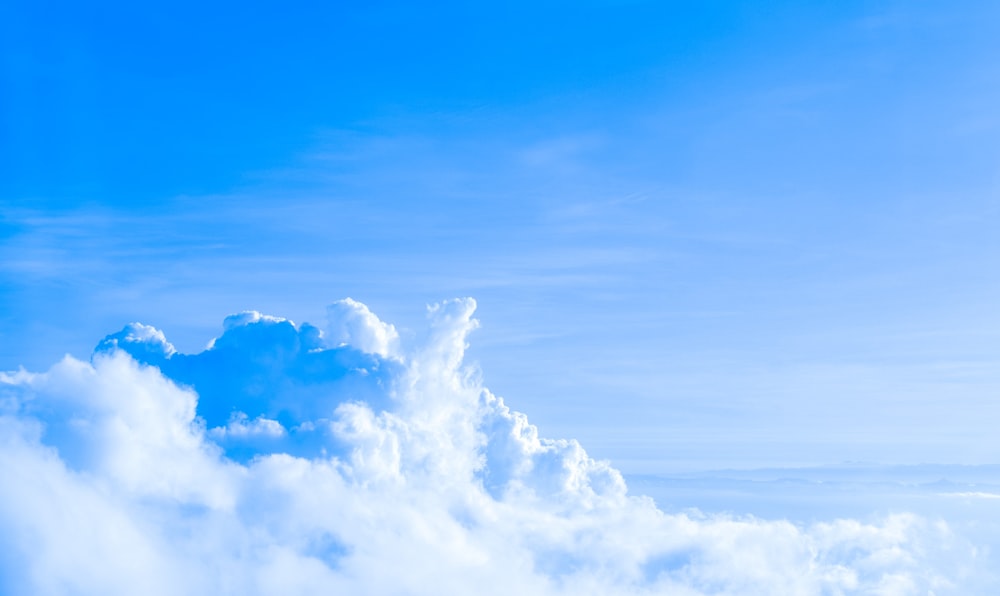 a plane flying in the sky with a lot of clouds