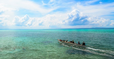 Tourists enjoying a scenic Hawaiian canoe ride along the coastline.