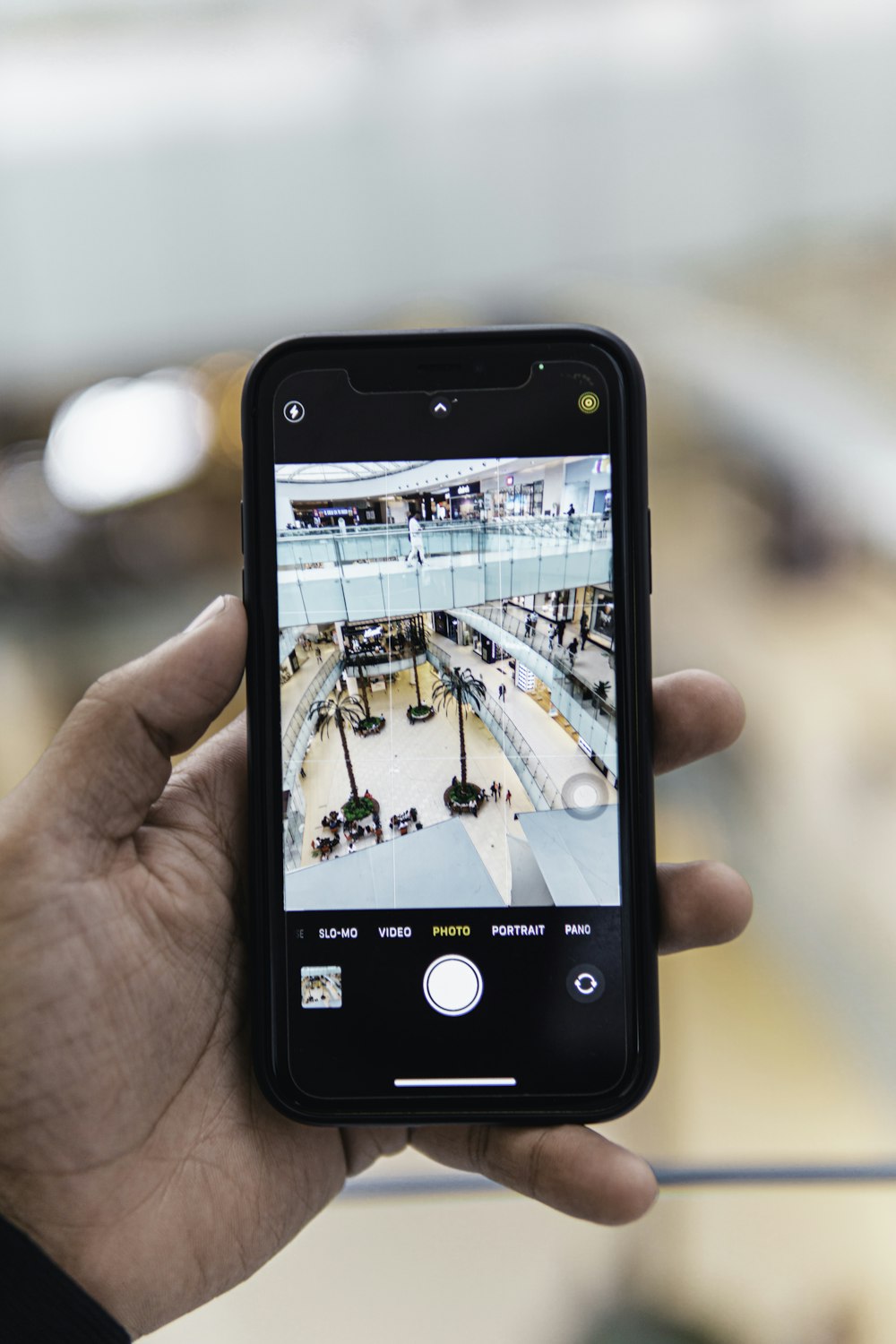 a hand holding a cell phone with a picture of a store