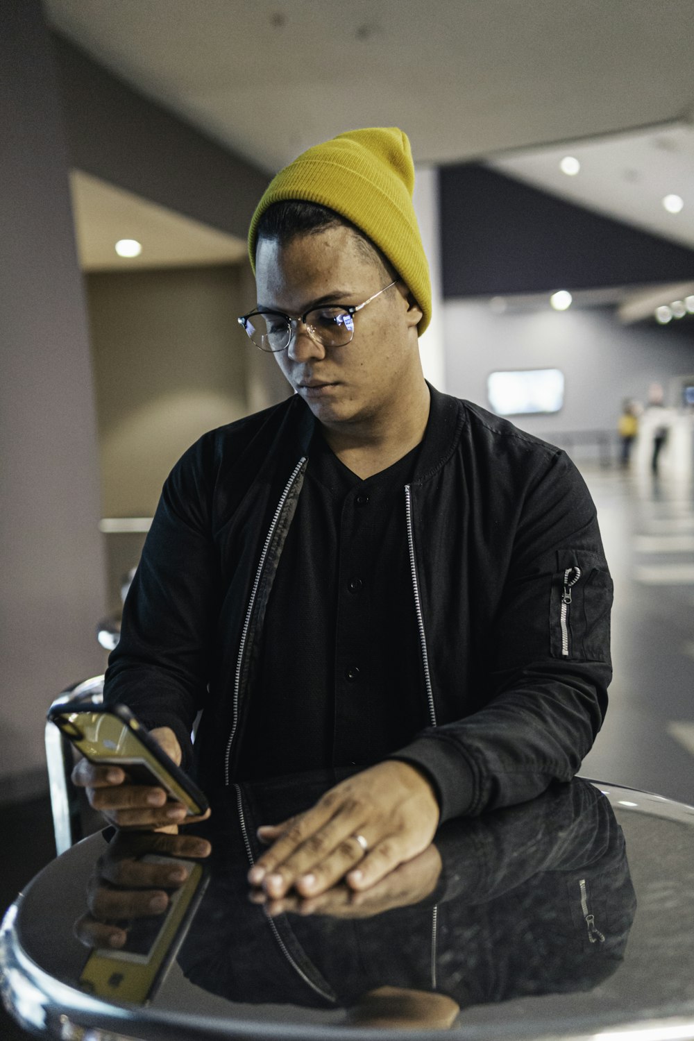 a man sitting at a table looking at his cell phone