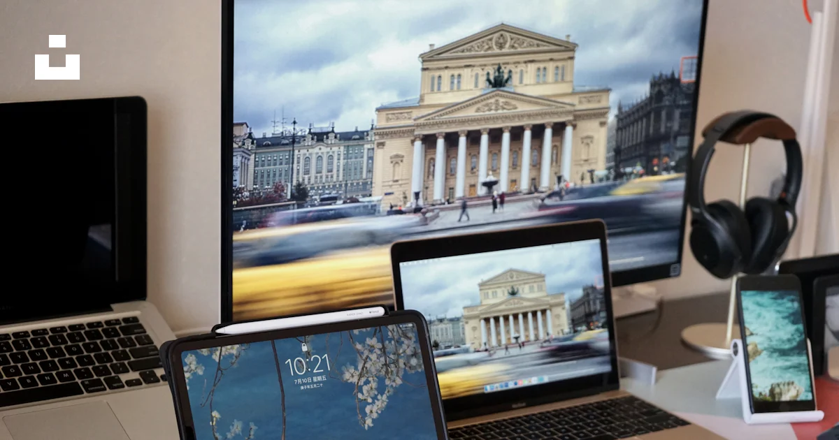 A desk with two laptops and a desktop computer photo – Free Table ...