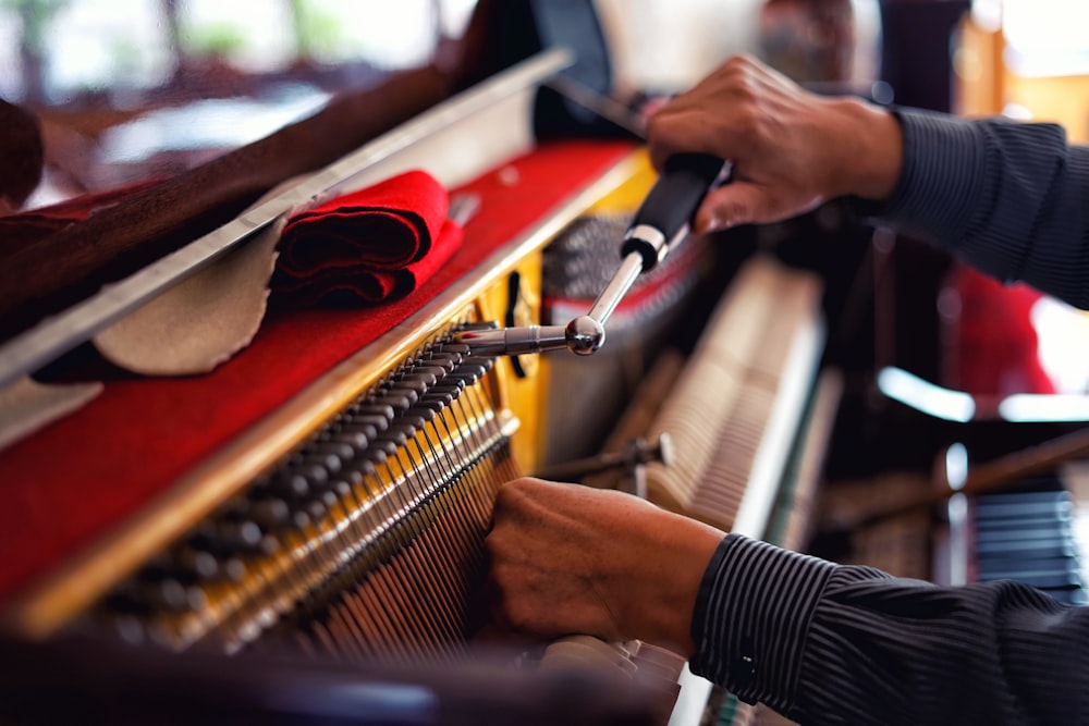 a person playing a piano with a pair of scissors