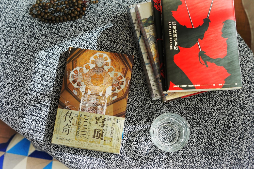 a table topped with books and a glass of water